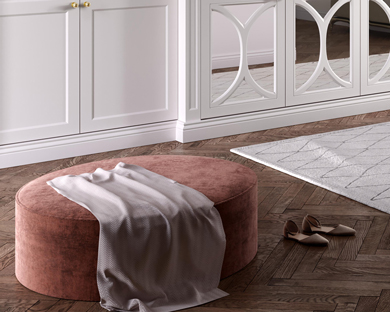 dusky pink foot stool in bedroom with satin throw