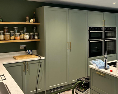 makeover after kitchen renovation, green cabinet doors and appliance integrations